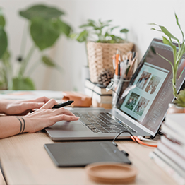 Open laptop with hands typing