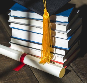 graduation cap and stack of books