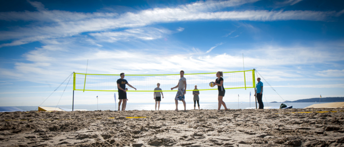 students playing beach volleyball