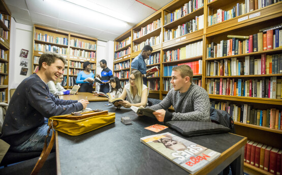 Several students sitting in the Arts & Humanities library.