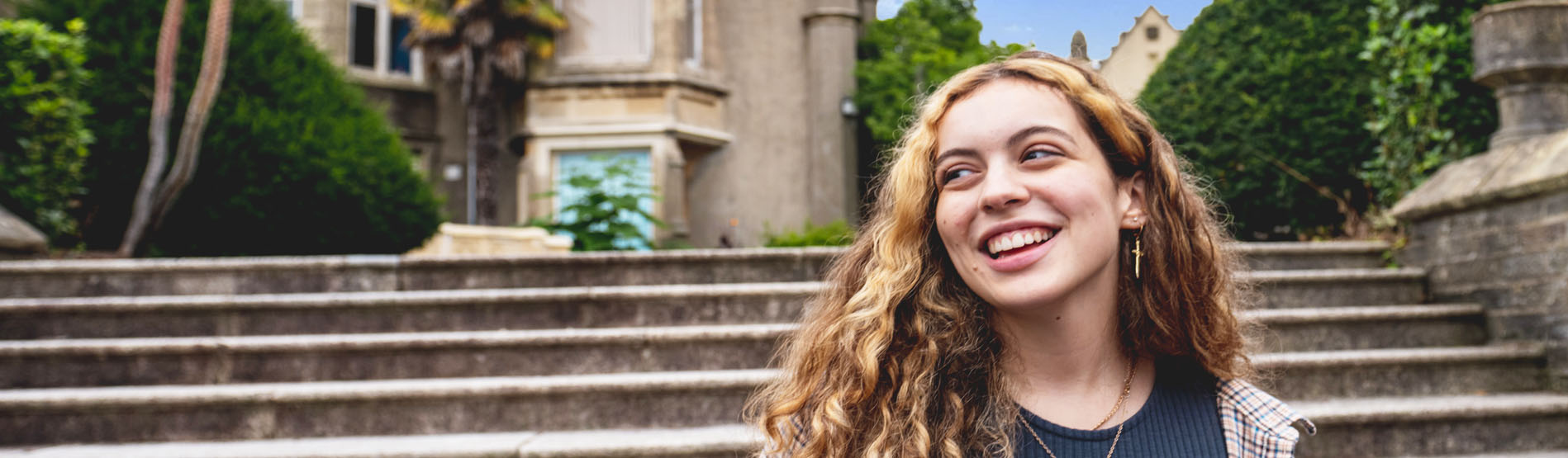 A student walking by the Abbey on Singleton Campus