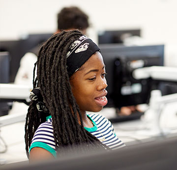 Close up of a girl working on a laptop