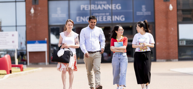 Two employers and two student chatting and walking 