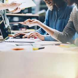 Group of people working around a desk