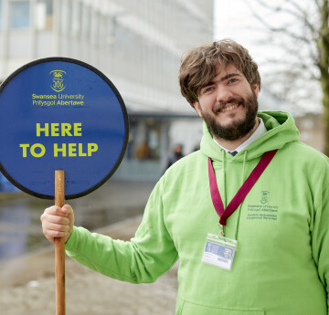 Student Ambassador Holding a Lollipop