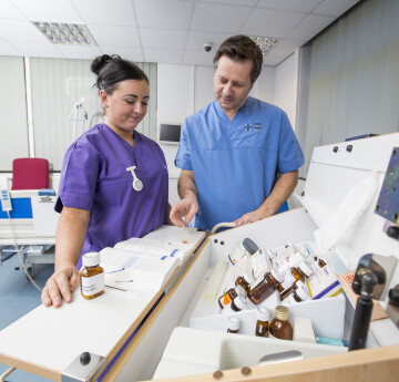 nursing students looking at equipment