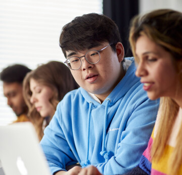 Students looking at laptop