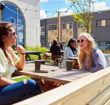 students sitting outside chatting