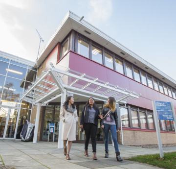 Female students walking outside Law building