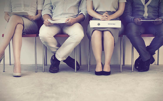 four people sitting in a waiting room