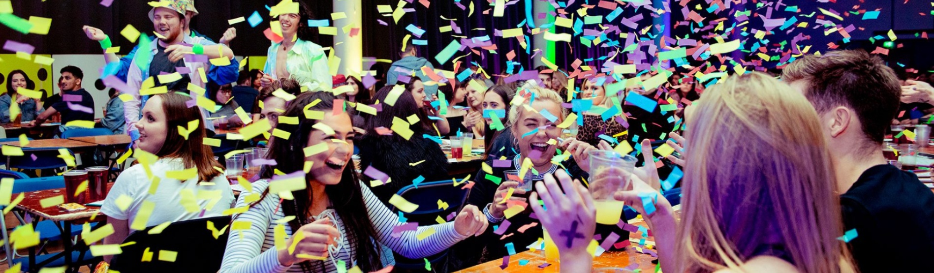 Students at a social event being showered with confetti