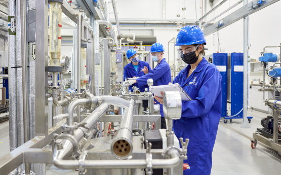 Engineer in health and safety equipment  performing checks using engineering facilities. 