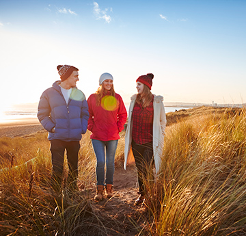 Three students walking in the SSSI at the Bay Campus