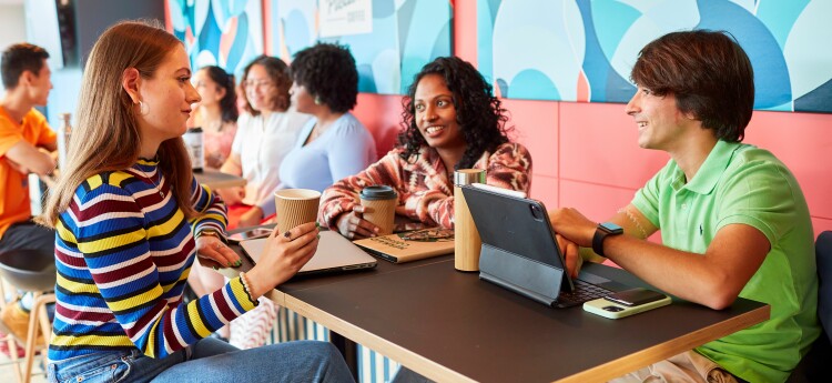 Students sitting at a table on Singleton Campus