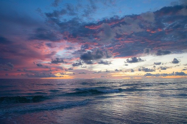 Sunset at sea, with blue, purple and orange colours in the sky